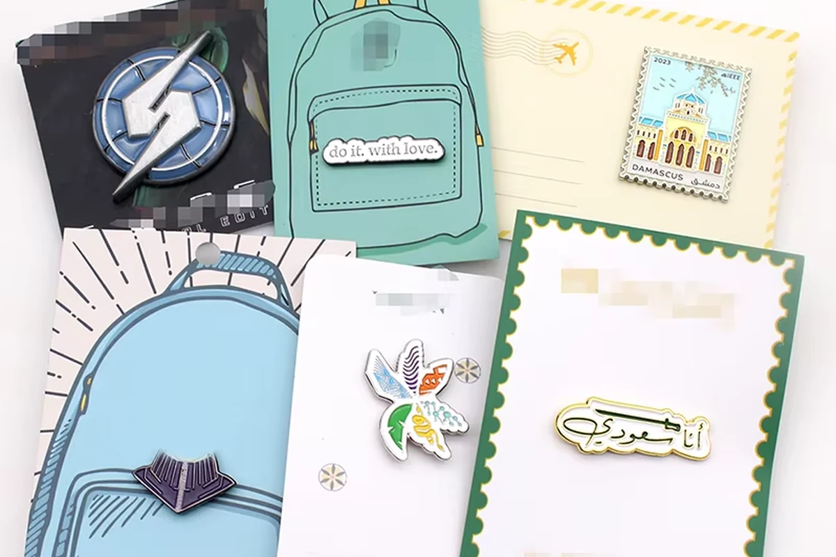 Assorted pins mounted on printed backing cards.