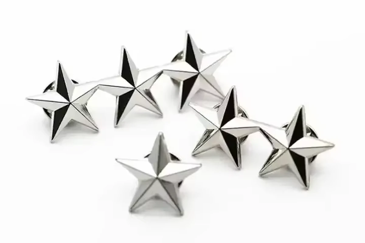 Six silver-colored star pins with faceted surfaces.