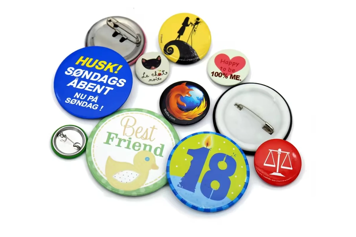 Assorted colorful round button badges, including badges shown from the back.