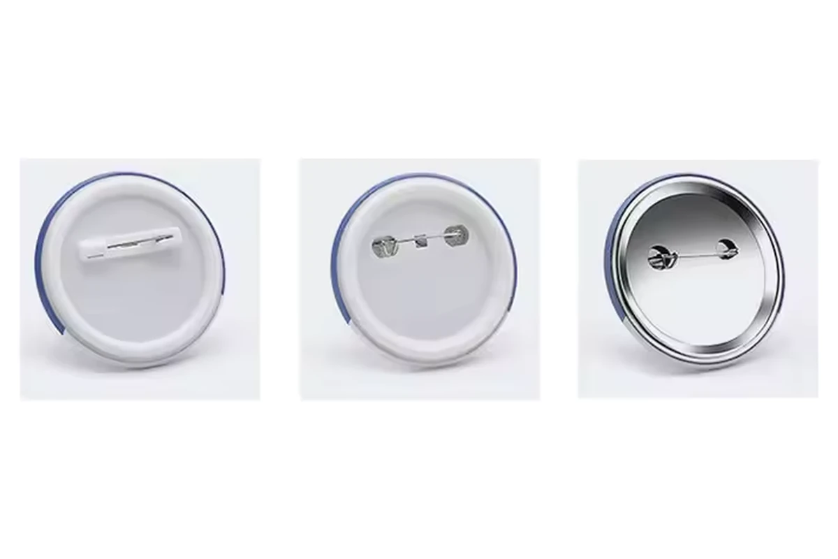 Round button badge backs with several safety-pin and pin-and-catch fittings.