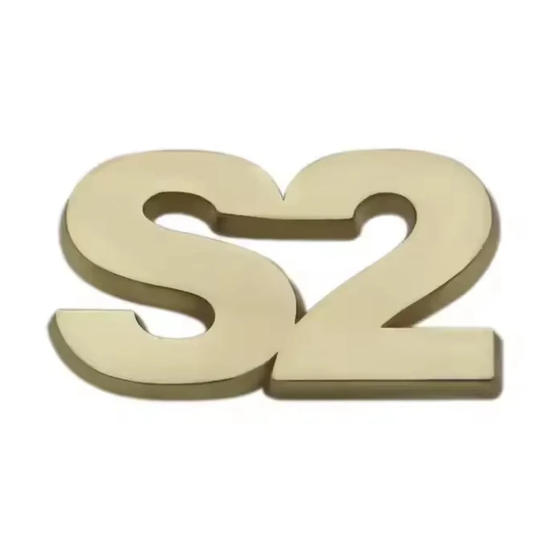 Gold S2-shaped cutout pin on white.