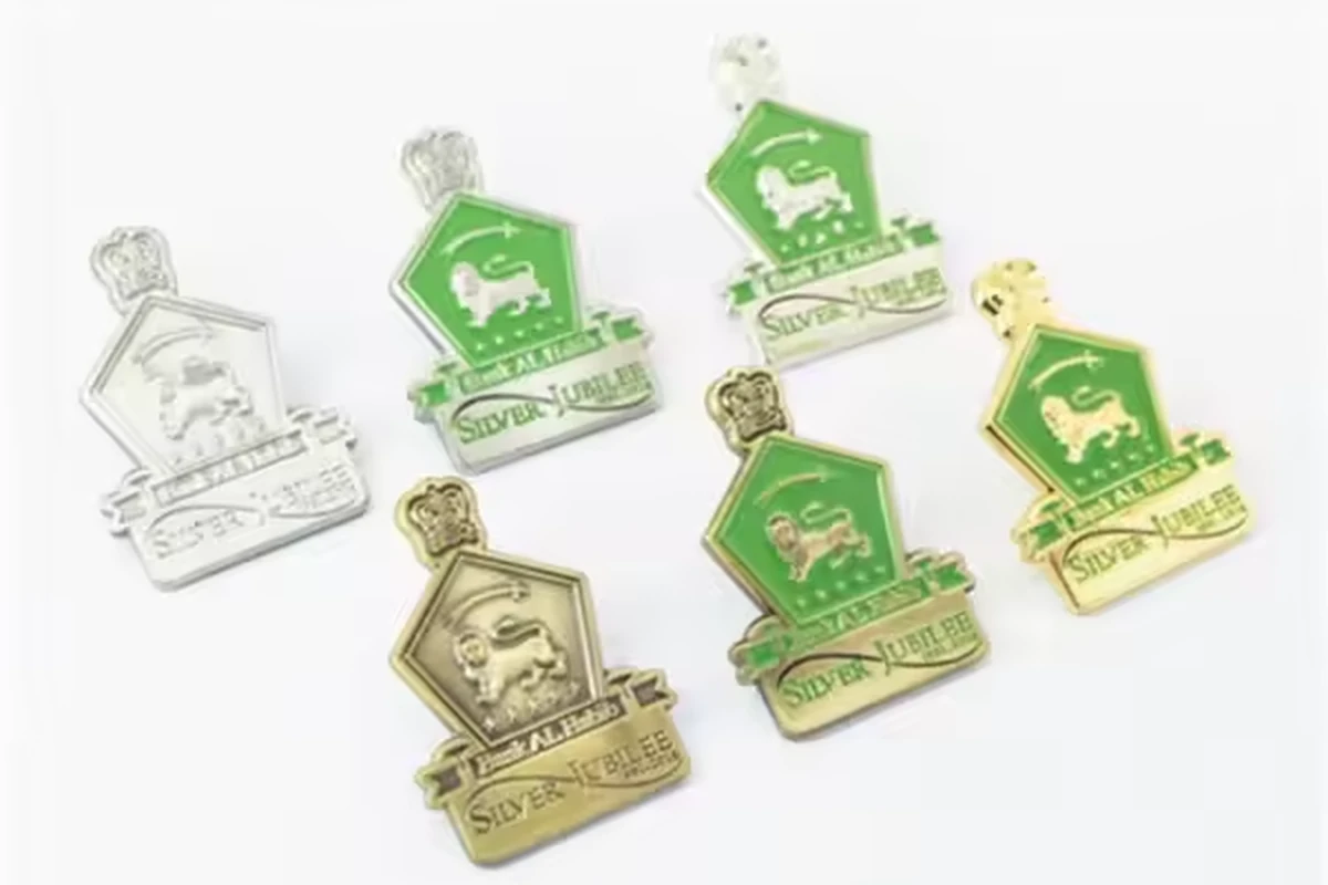 Matching green emblem badges shown with silver-colored, gold-colored and antique-colored metal borders.