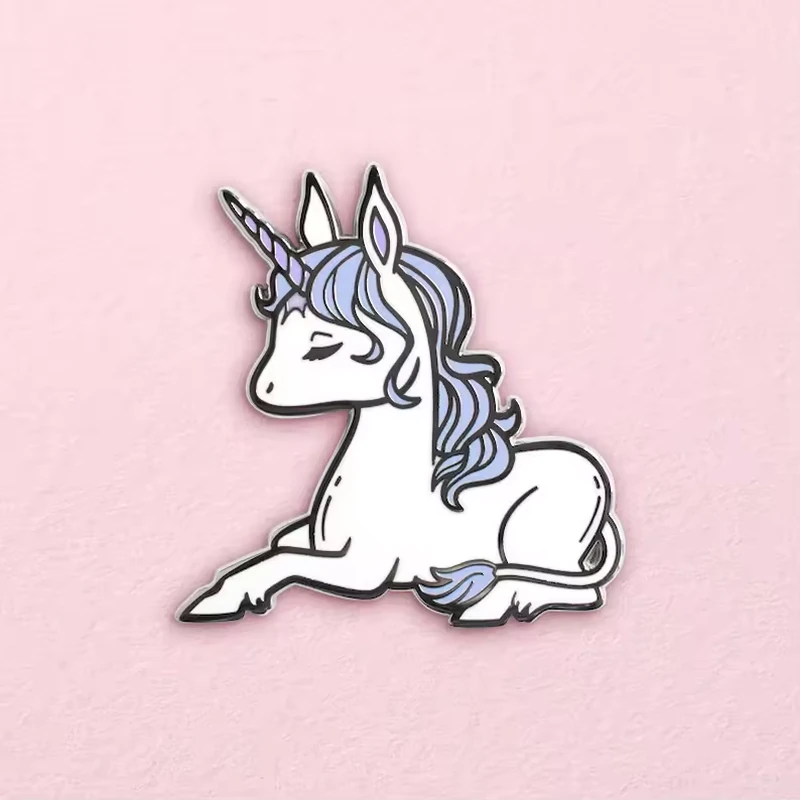 A white unicorn pin on a pink background.