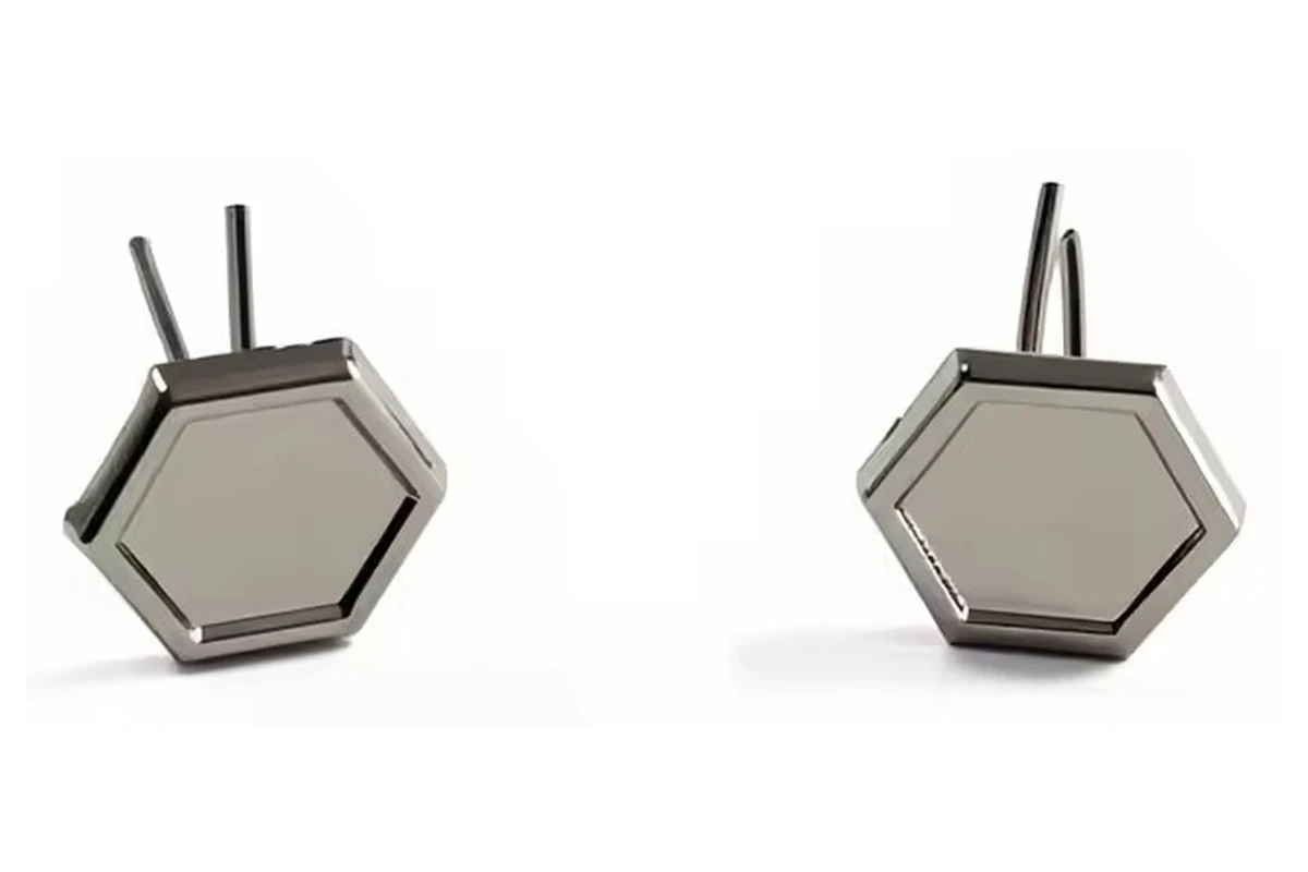 Two silver-colored hexagonal blank badge settings with raised rims and long metal posts.
