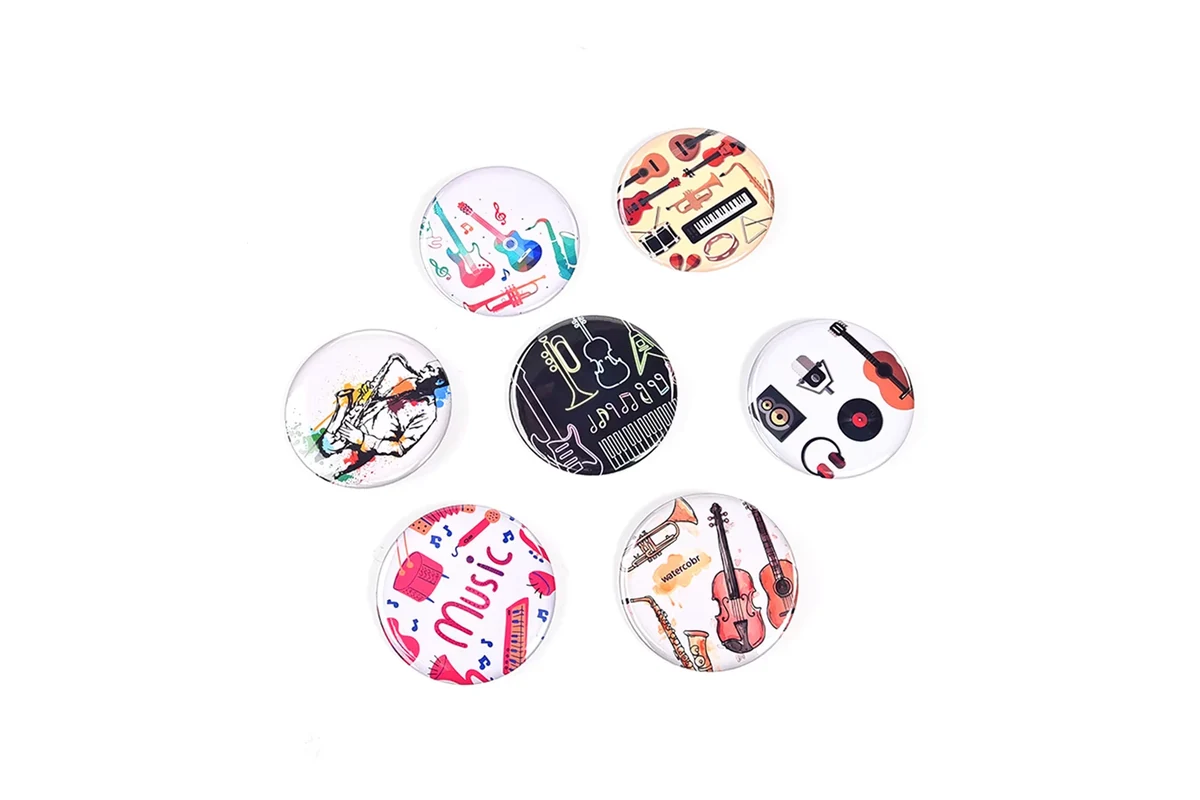 An assortment of round music-themed badges on white.