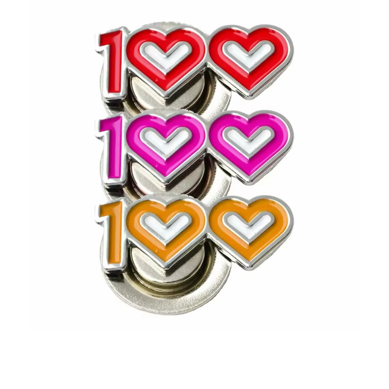 Three 100-shaped magnetic pins in red, pink and orange, each with two heart-outline zeros, silver-tone borders and round magnetic attachments on a white background.