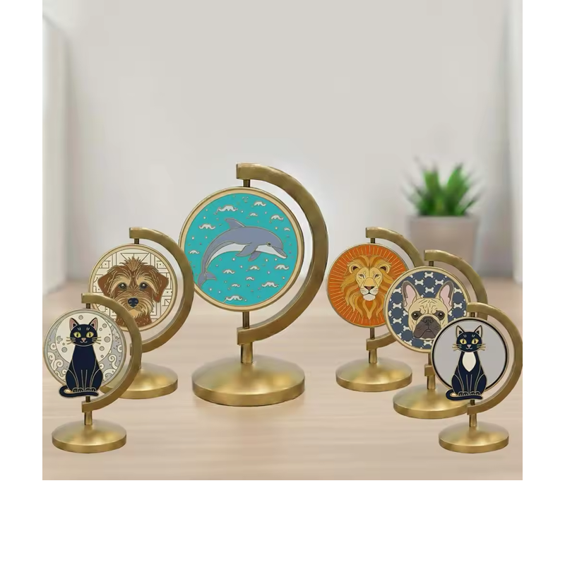 Six circular animal medallions depicting two cats, two dogs, a dolphin and a lion, held in gold-tone curved tabletop stands on a wooden surface.