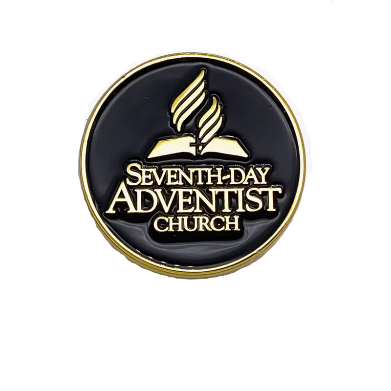 Round black church emblem pin with gold-tone outlines, an open book and flame symbol, and SEVENTH-DAY ADVENTIST CHURCH lettering on a white background.