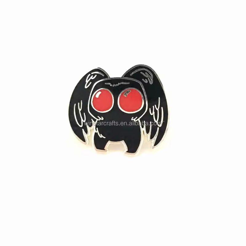 Black winged creature pin with large red eyes and silver-tone outlines on a white background, with the original supplier watermark visible.