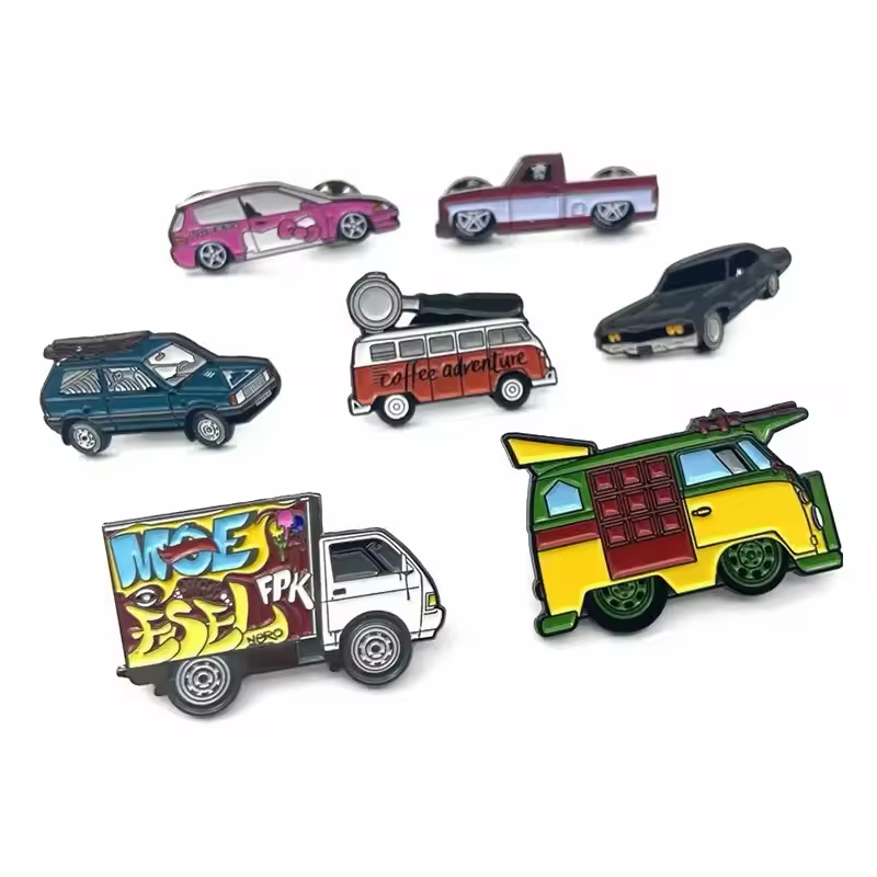 Seven vehicle pins showing a pink car, two-tone pickup, black car, teal station wagon, coffee adventure van, graffiti box truck and green-and-yellow van on white.