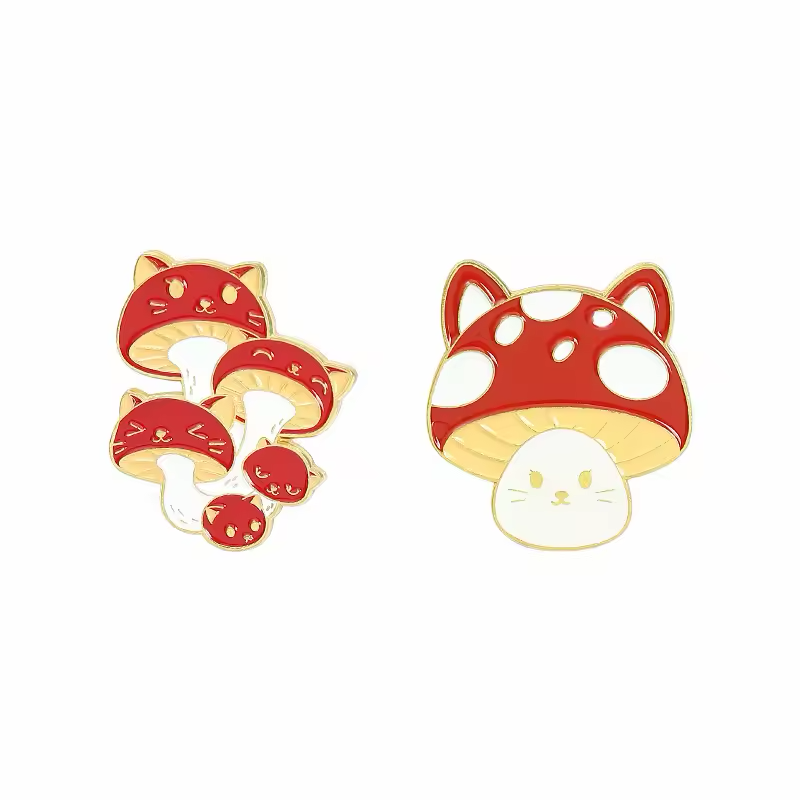 Two red and white cat-shaped mushroom pin designs with gold-colored borders.