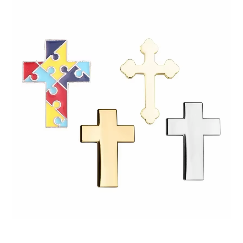 Four cross pins featuring a multicolored puzzle pattern, a rounded gold-colored design and plain gold- and silver-colored designs.