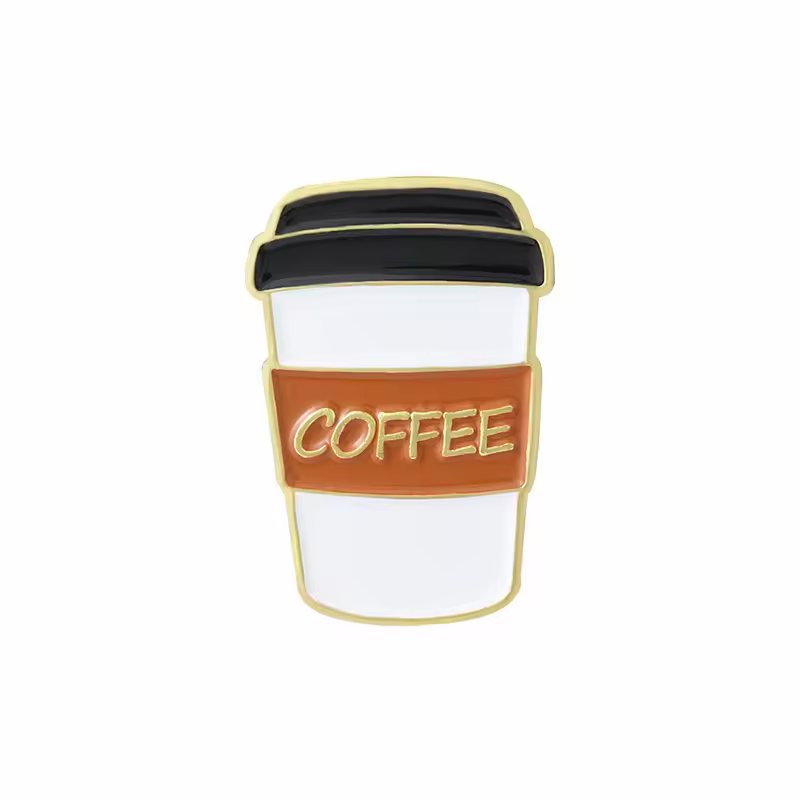 White takeaway coffee cup pin with a black lid, brown sleeve and gold-colored COFFEE lettering and outline.
