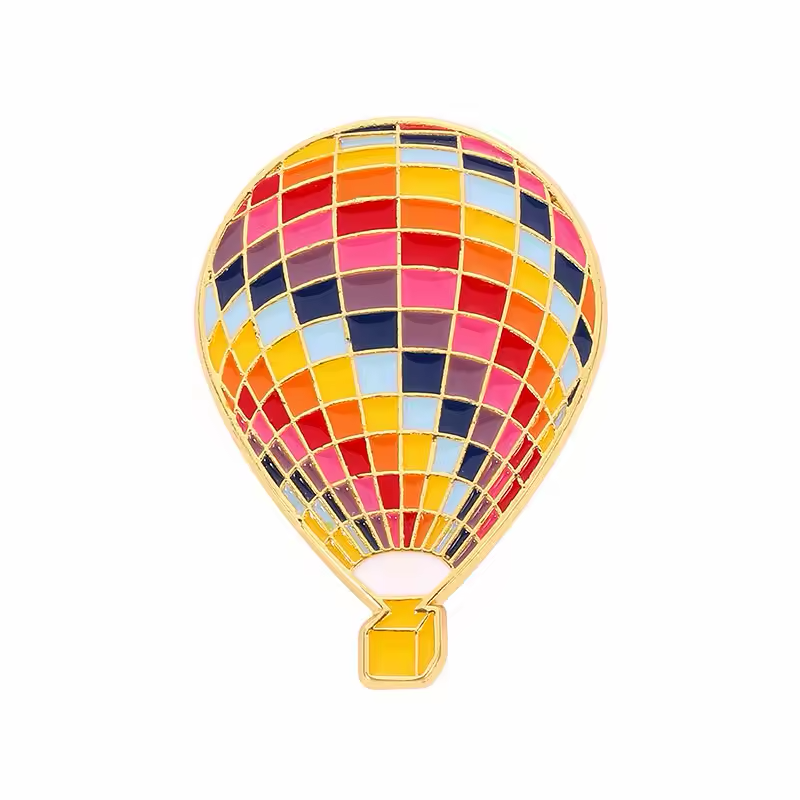 Hot air balloon pin with a multicolored grid, gold-colored outlines and a yellow basket.