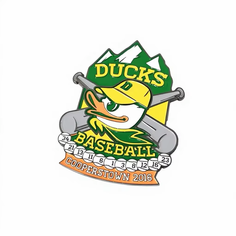 Green and yellow baseball pin with a duck character in a cap, crossed bats, numbered baseballs, mountain shapes and DUCKS BASEBALL COOPERSTOWN 2016 lettering on a white background.