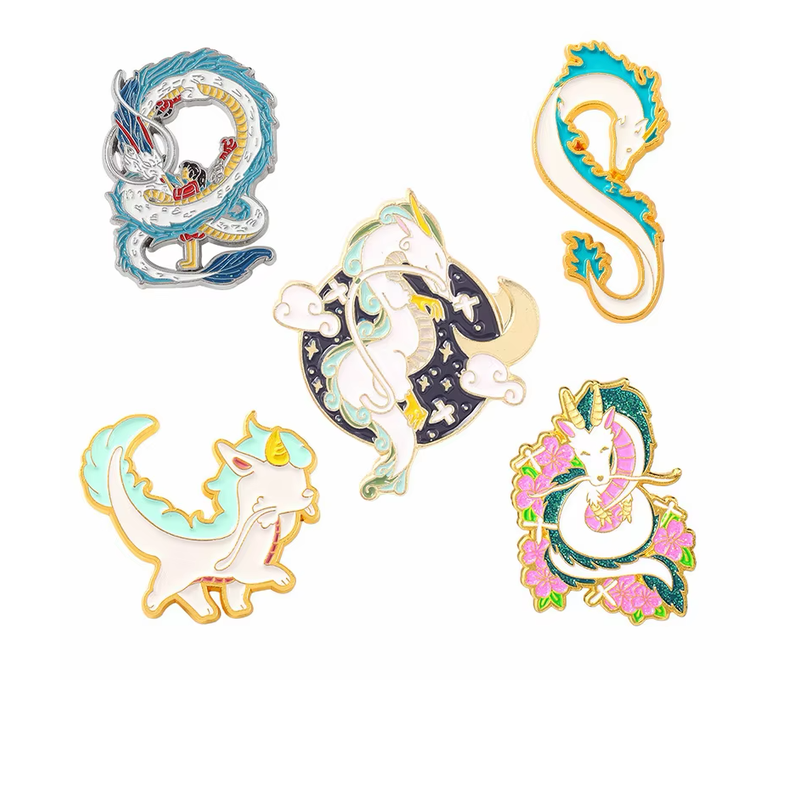 Five fantasy dragon pins with coiled, floral, moon-and-star and pastel designs.
