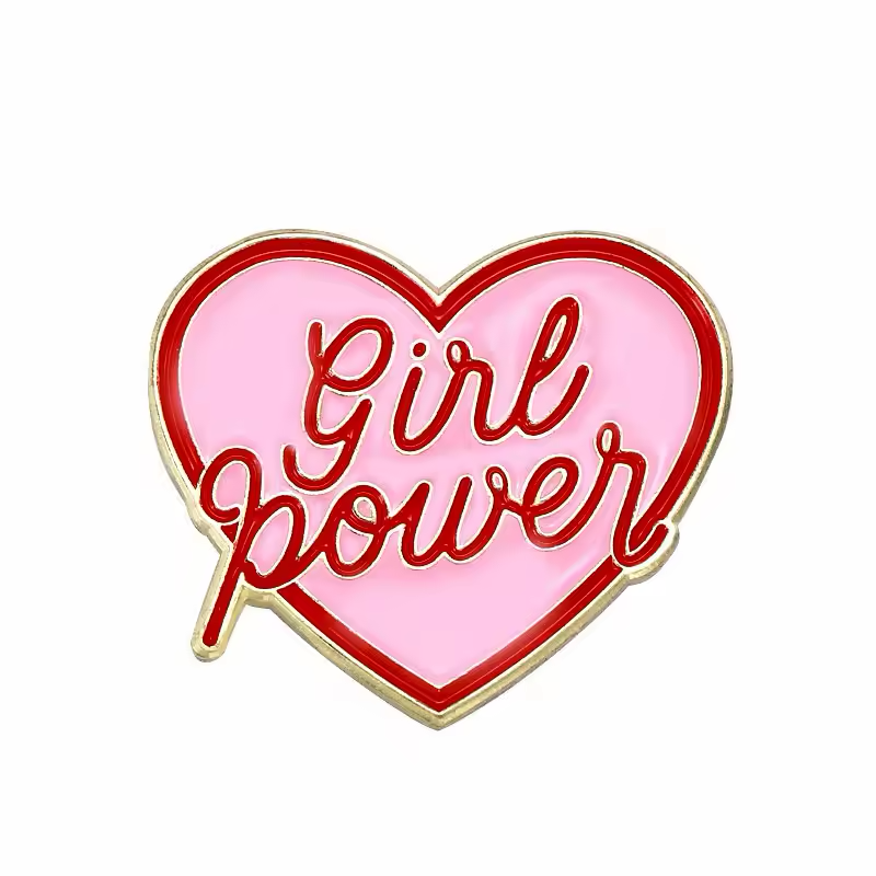 Pink heart-shaped pin with red Girl Power lettering and a gold-colored outline.