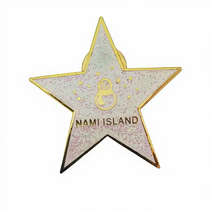 Glitter-filled star souvenir pin with a gold-colored border, a small snowman motif and Nami Island lettering.