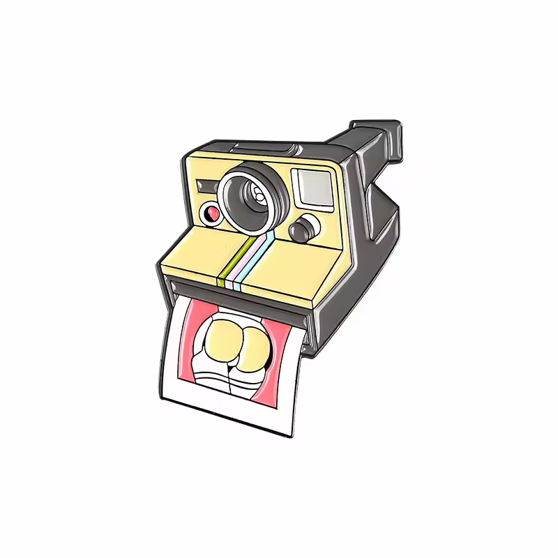 Yellow instant camera pin with a rainbow stripe and an emerging illustrated photo.