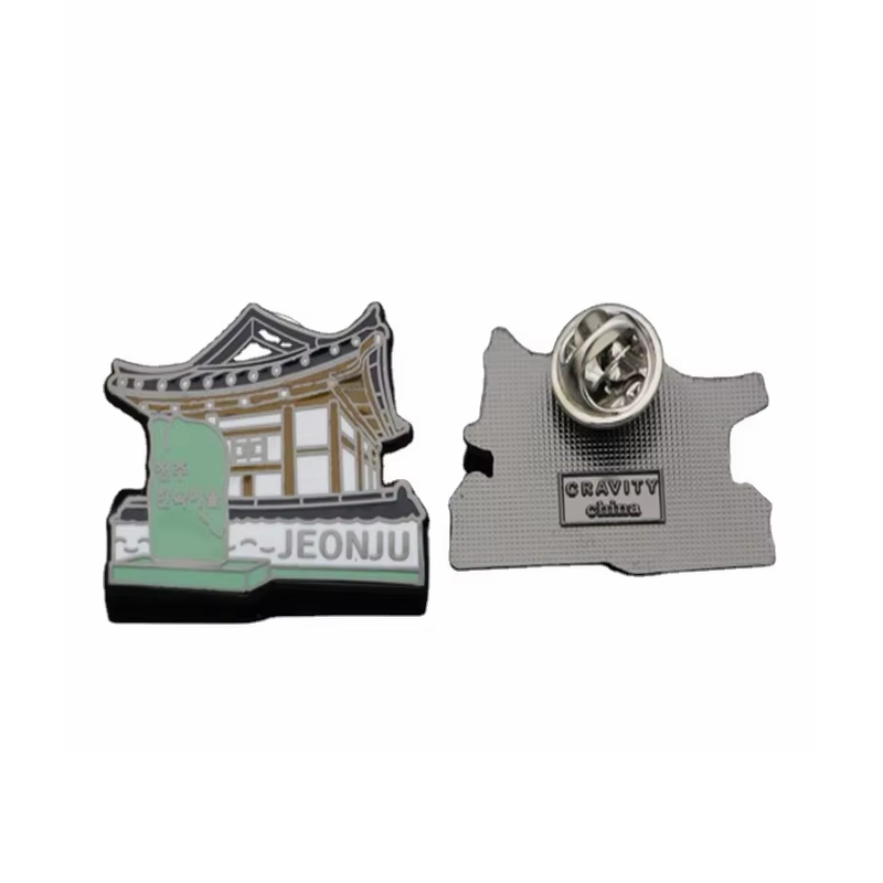 Jeonju souvenir pin shaped around a traditional building and green stone marker with JEONJU lettering, shown beside its textured back and butterfly clutch on a white background.