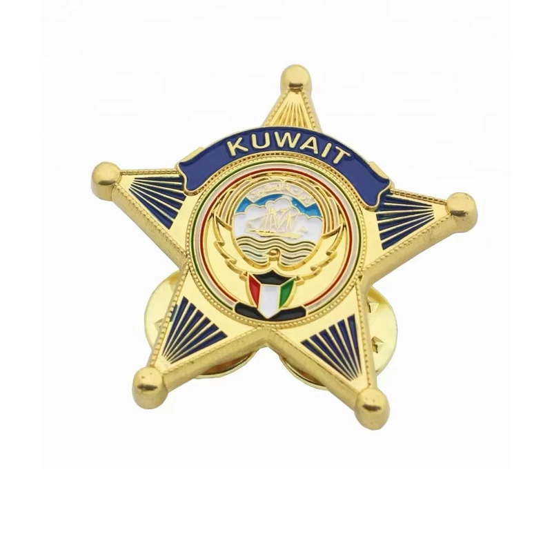 Gold-colored five-point star pin with dark blue details, KUWAIT lettering and a central emblem.