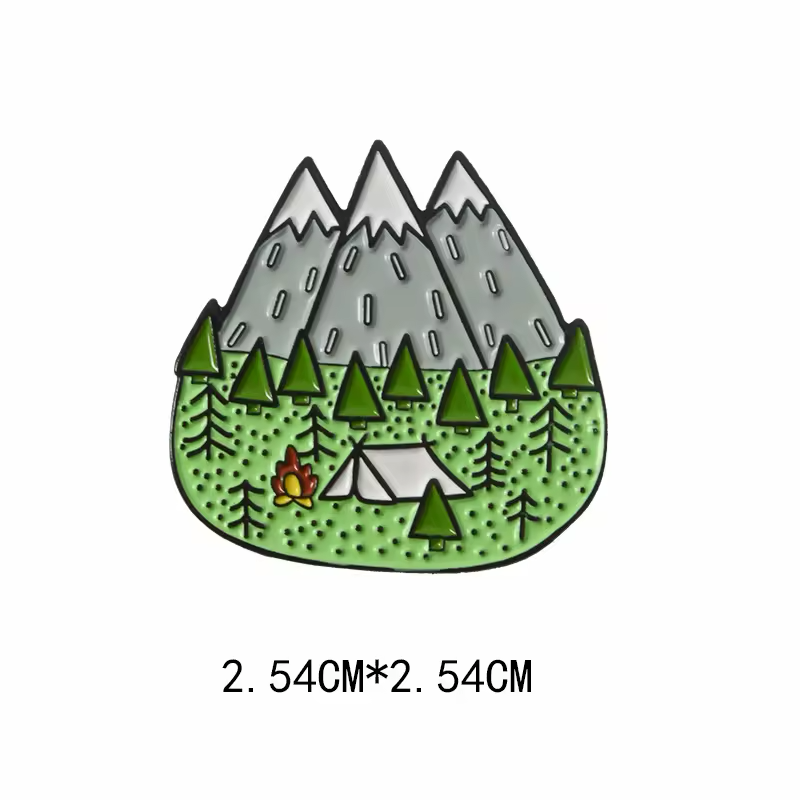 Mountain camping pin with three snowcapped peaks, green pine trees, a tent and a campfire, with a 2.54 cm by 2.54 cm label below.