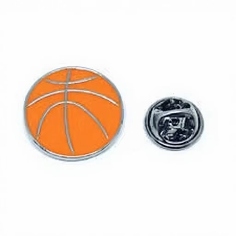 Orange basketball pin with silver-tone outlines and curved ball seams, shown beside a silver-tone butterfly clutch on a white background.