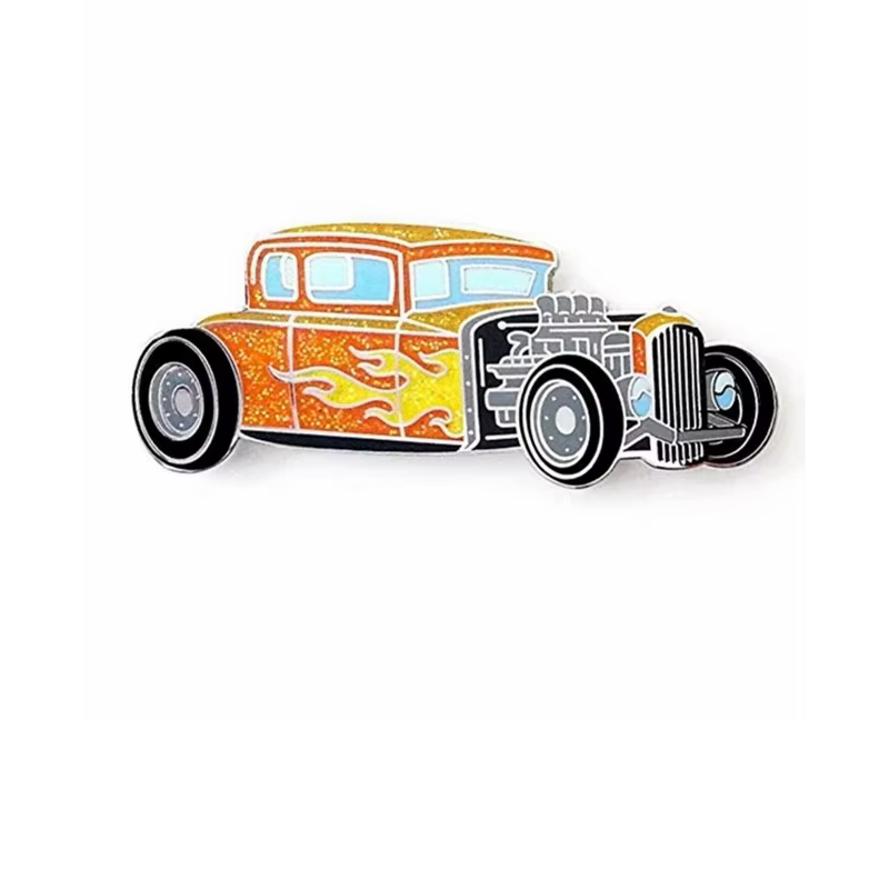 Orange and gold glitter hot rod car pin with yellow flame graphics, pale blue windows, an exposed engine and black tires on a white background.