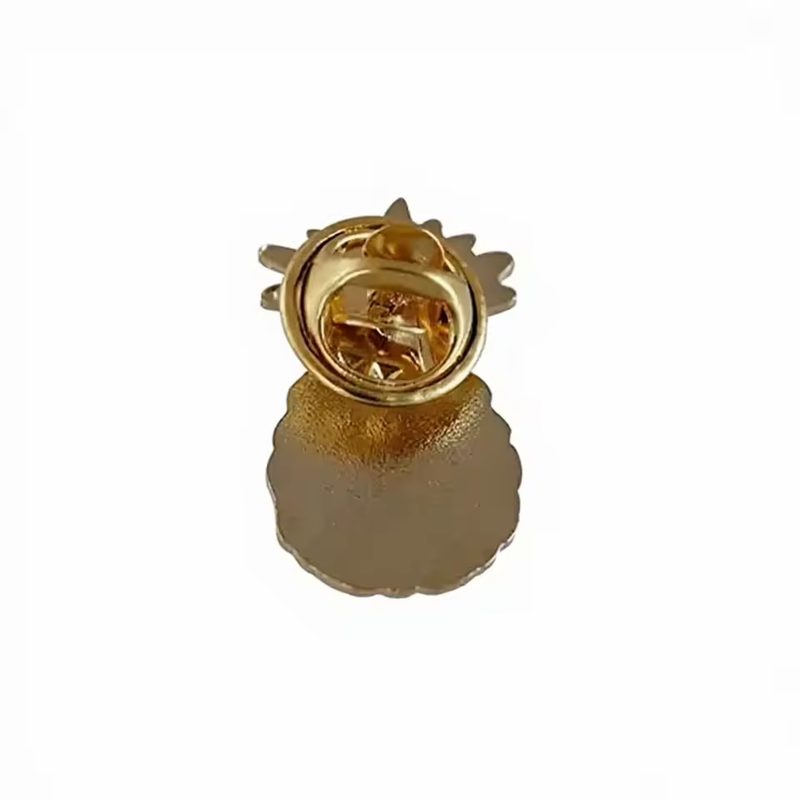 Back of a pineapple-shaped pin with a textured gold-tone surface and a gold-tone butterfly clutch on a white background.