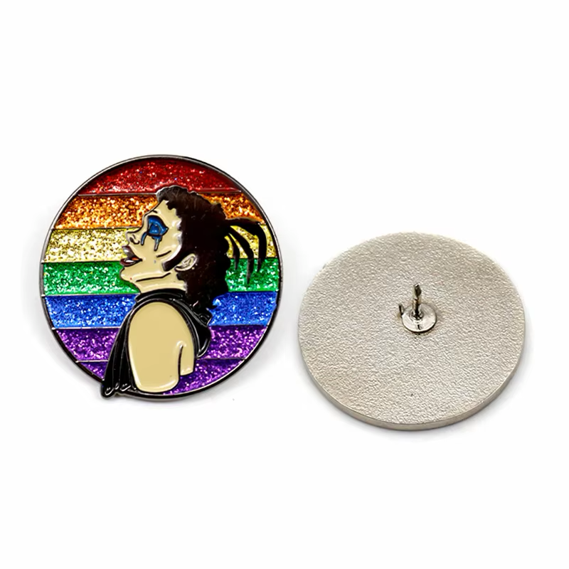 Character portrait pin on a rainbow glitter background, shown with its silver-colored back and single post.