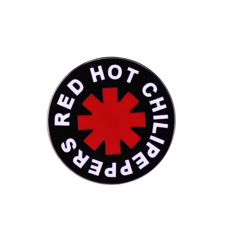 Black round badge with a red asterisk and white Red Hot Chili Peppers lettering.