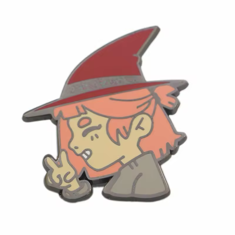 Cartoon witch pin with orange hair, a red pointed hat, a gray collar and a raised two-finger hand gesture on a white background.