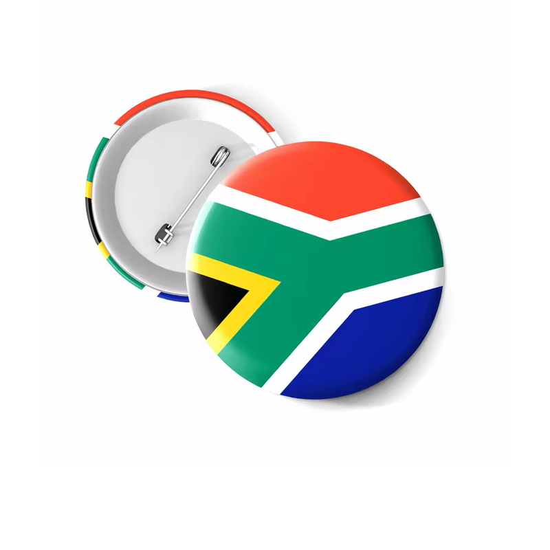 Round South Africa flag button badge in red, blue, green, white, yellow and black, shown beside its silver-tone pin-back reverse on a white background.