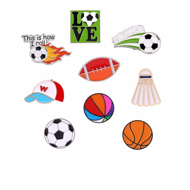 Sports pin assortment featuring soccer designs, an orange basketball, a multicolored ball, an American football, a shuttlecock and a cap.