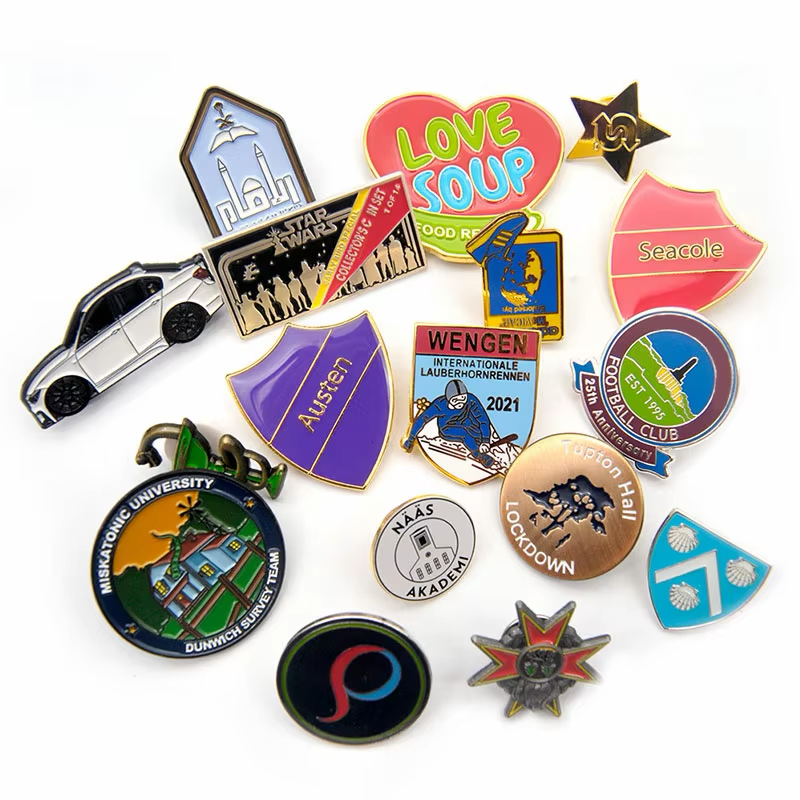 Assorted pins with sports, school, club and souvenir emblems, including shield, round, star, heart and car shapes.