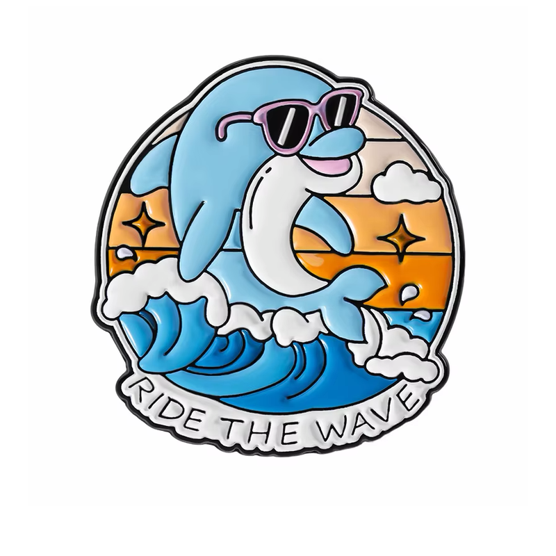 Blue dolphin pin wearing purple sunglasses above ocean waves, with the words Ride the Wave.