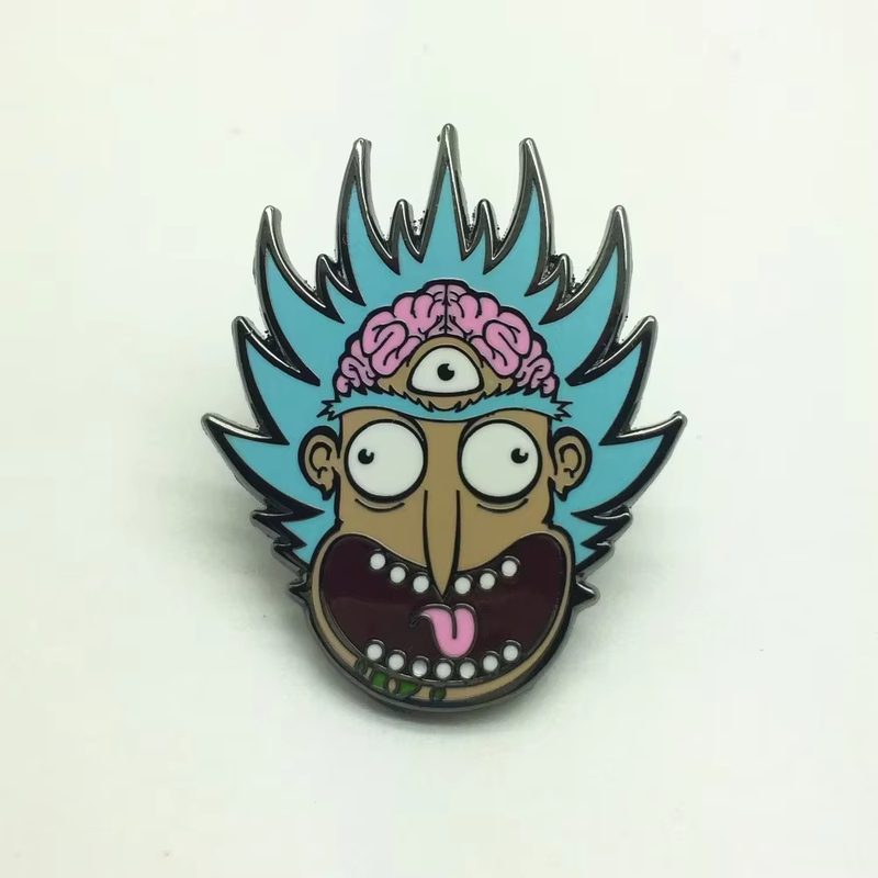 Blue-haired, three-eyed cartoon face pin with a pink brain detail, resting on a pale background.