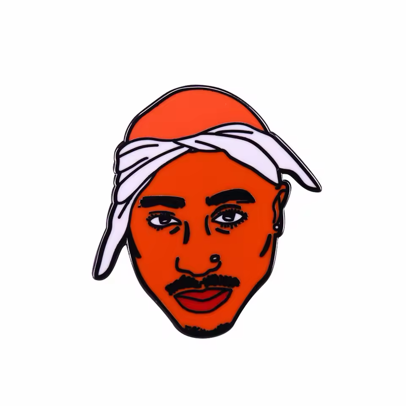 Portrait pin with an orange face, a white tied bandana, black eyebrows, a mustache and a small goatee on a white background.