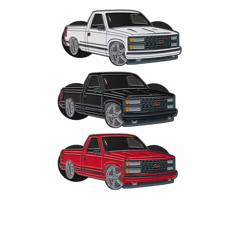 Three lowered pickup truck pins in white, black and red with dark windows, silver-tone grilles and large gray wheels on a white background.