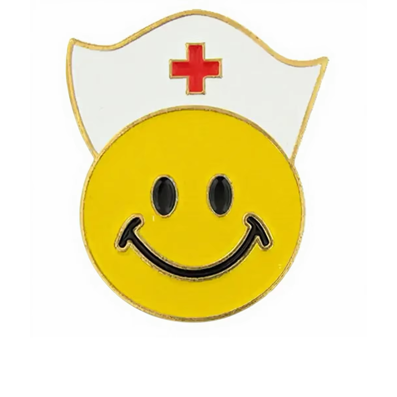Yellow smiley face pin wearing a white nurse cap with a red cross, black oval eyes and gold-tone outlines on a white background.