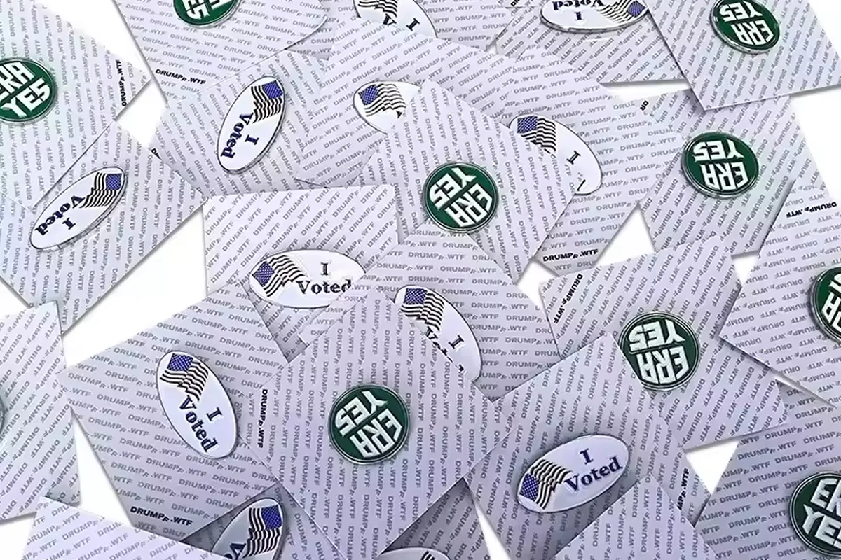 A large batch of small pins on patterned backing cards.